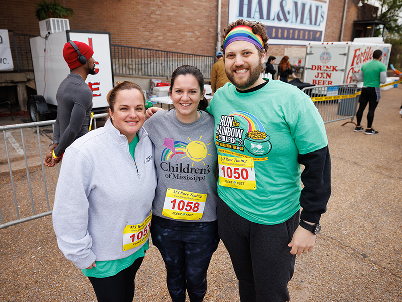 Pediatric ICU nurses Lauren Gordon and Colby Baird and PICU nurse manager Gordon Gartrell smile for a photo before the start of the first Run the Rainbow for Children's earlier this year.